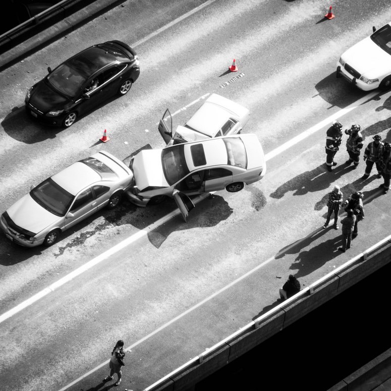 black and white photo from above a multi-car crash on the highway