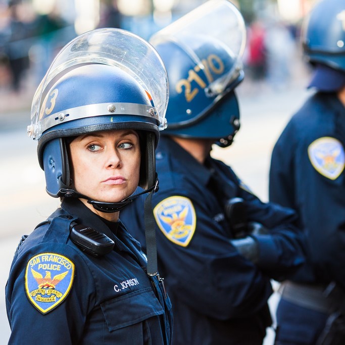 A group of police officers hearing helmets and face shields.