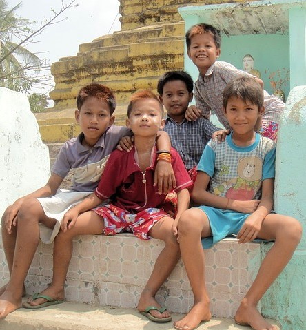 group of children posing and sitting closely 