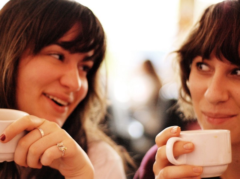 photo of two women chatting over coffee