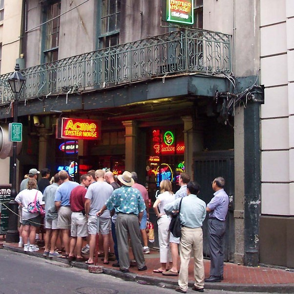 photo of people waiting outside in a line