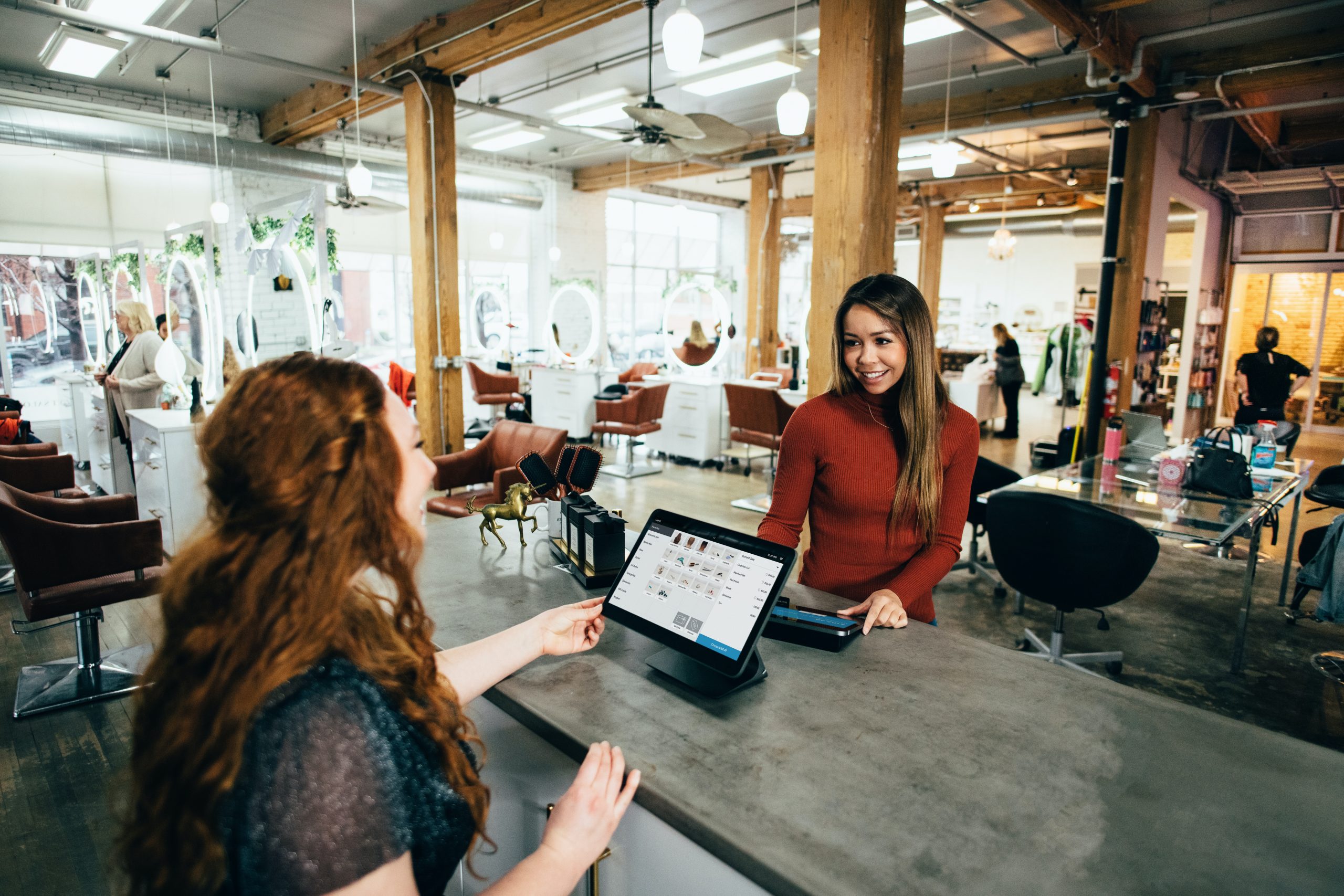 Customer paying at checkout for service received