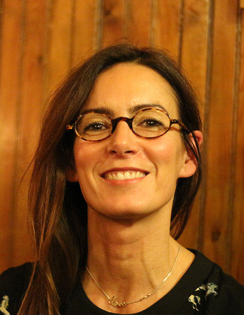 Isabel Casanova, a white woman with long dark hair and glasses smiling