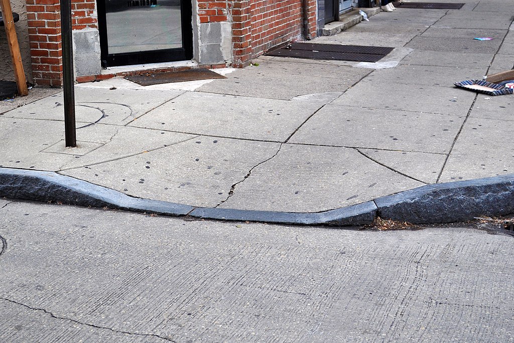 A curb cut at the edge of a street