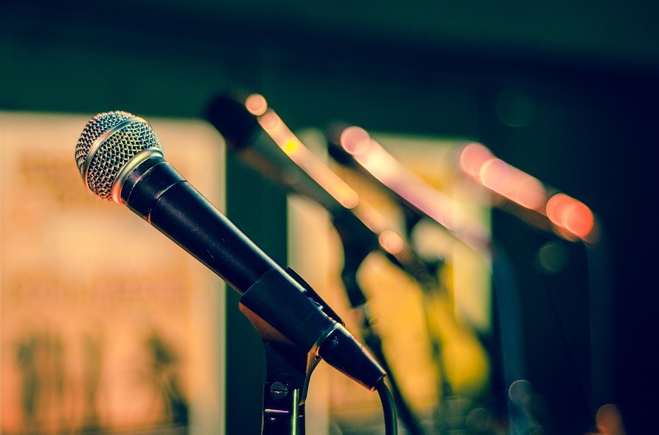 a row of microphones on a stage