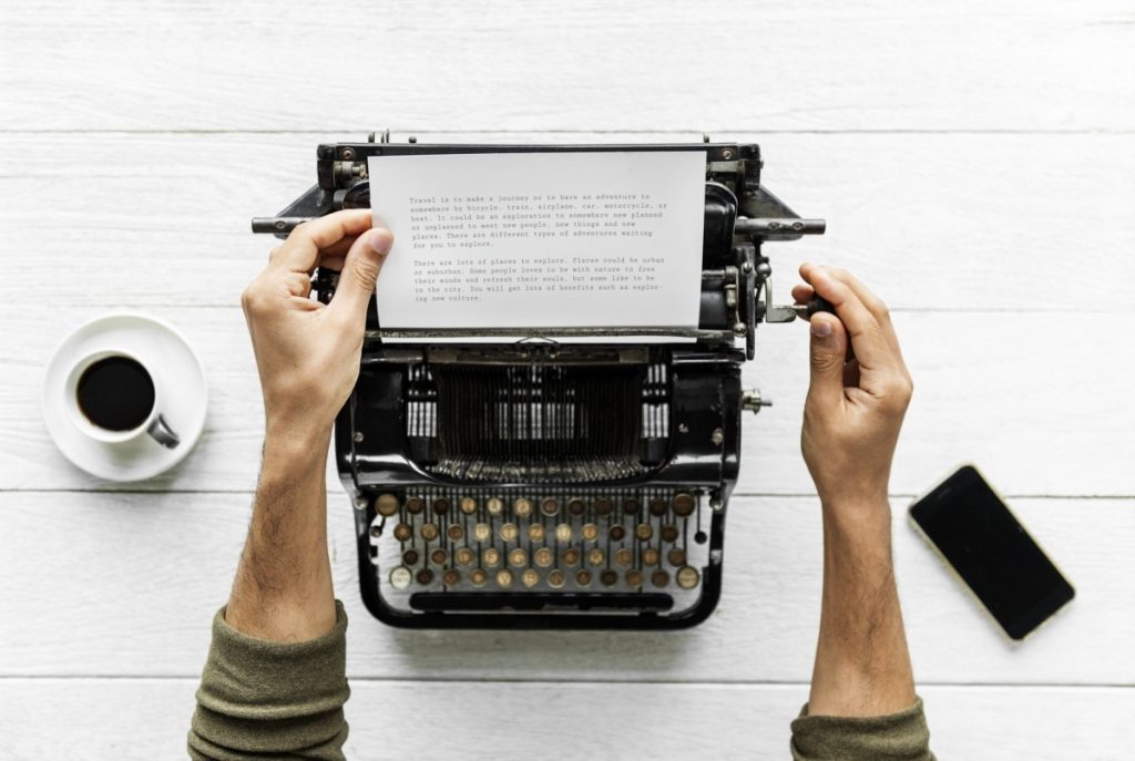 a person typing at a typewriter