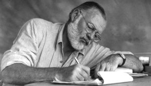 Figure 3.7A American writer Ernest Hemingway working at a portable table while on a big game hunt in Kenya, September 1952.